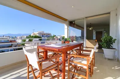 a wooden table and chairs on a balcony at Chalandri Family Penthouse - 1' from metro station in Athens