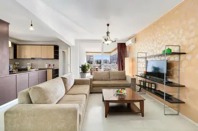 a living room with a couch and a table at Chalandri Family Penthouse - 1' from metro station in Athens