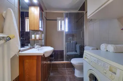a bathroom with a sink and a shower and a toilet at Chalandri Family Penthouse - 1' from metro station in Athens