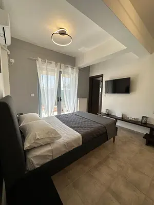 a bedroom with a bed and a flat screen tv at Elegant Escapes 4 in Athens