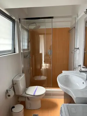 a bathroom with a shower and a toilet and a sink at Elegant Escapes 4 in Athens