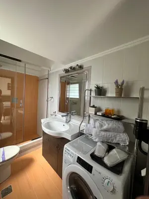 a bathroom with a washing machine and a sink at Elegant Escapes 4 in Athens