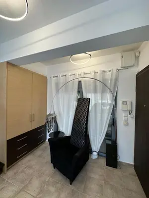 a living room with a chair and a window at Elegant Escapes 4 in Athens