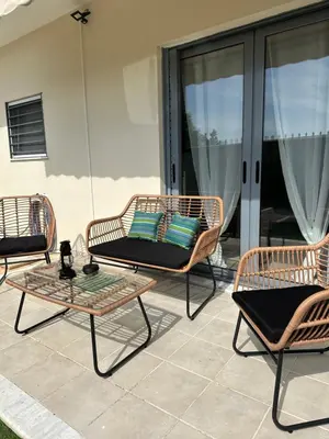 three rattan chairs and a table on a patio at Elegant Escapes 4 in Athens