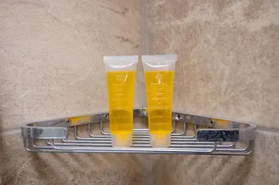 two glasses of beer sitting on a metal shelf at AIOLOS GLYFADA super lux suite 5 sea view in Athens