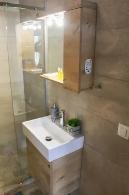 a bathroom with a sink and a shower at AIOLOS GLYFADA super lux suite 5 sea view in Athens