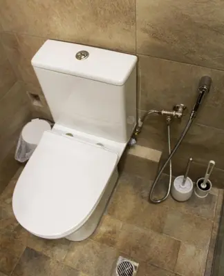 a white toilet in a bathroom with a shower at AIOLOS GLYFADA super lux suite 5 sea view in Athens