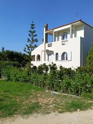 a white house on the side of a hill at Porto Rafti Hideaway in Porto Rafti
