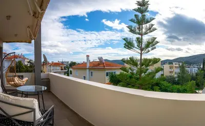 a balcony with a view of a pine tree at Porto Rafti Hideaway in Porto Rafti