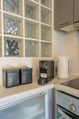 a kitchen with a counter top with cups and appliances at Porto Rafti Hideaway in Porto Rafti
