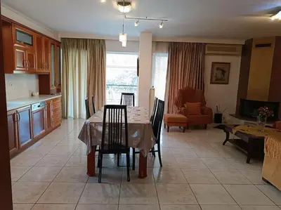 a kitchen and living room with a table and chairs at Katerina's apartment in Athens