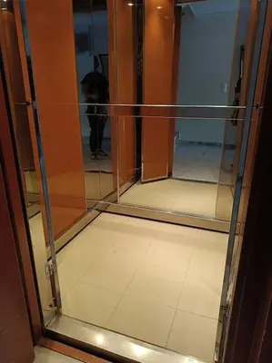 a glass door in a room with a person in the background at Katerina's apartment in Athens