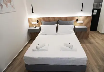 a bedroom with a large bed with two mice on it at Platon Stylish Apartment in Athens