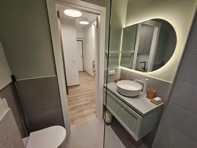 a bathroom with a sink and a mirror at Platon Stylish Apartment in Athens