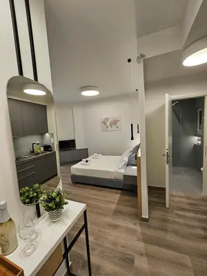 a room with a bed and a table in a room at Platon Stylish Apartment in Athens