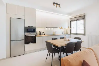 a kitchen and dining room with a table and chairs at Lavish condo in Athens Riviera in Athens