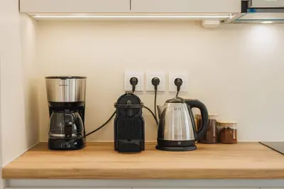 a kitchen counter with two appliances on a shelf at Lavish condo in Athens Riviera in Athens
