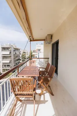 a balcony with a table and chairs on a balcony at Lavish condo in Athens Riviera in Athens