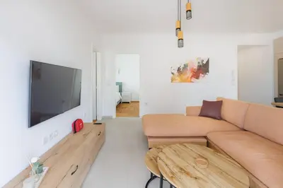 a living room with a couch and a flat screen tv at Lavish condo in Athens Riviera in Athens