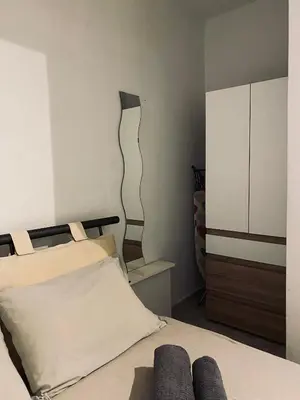 a bedroom with a bed and a dresser at Cosy House Glyfada in Athens