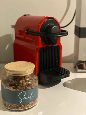 a small jar of spices next to a coffee maker at Cosy House Glyfada in Athens