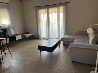 a living room with a couch and a coffee table at Zinia House in Porto Rafti