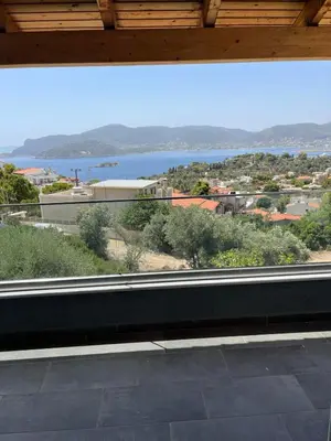a large window with a view of the water at Zinia House in Porto Rafti