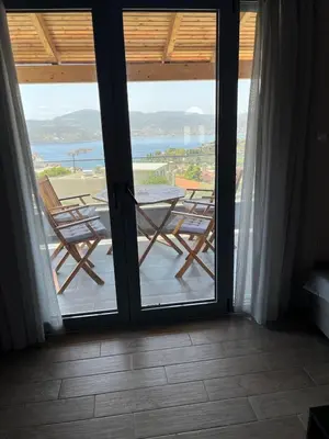 a view of a patio with a table and chairs at Zinia House in Porto Rafti