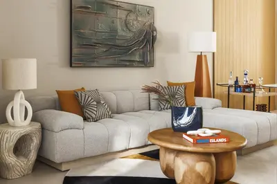 a living room with a couch and a table at One&Only Aesthesis, Athens in Athens