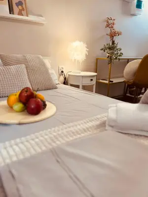 a plate of fruit sitting on top of a bed at Cactus Luxury suite1 in Athens