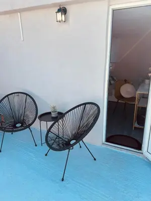 two chairs and a table in a room at Cactus Luxury suite1 in Athens