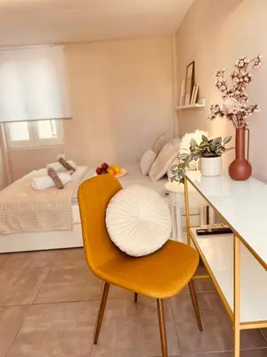 a bedroom with a bed and a table and a chair at Cactus Luxury suite1 in Athens