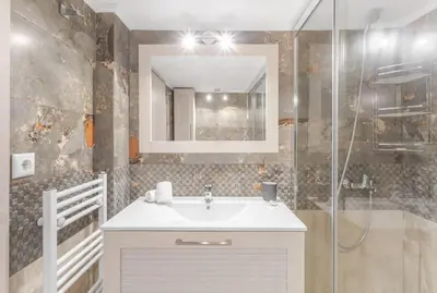 a bathroom with a sink and a mirror at Afroditi Suite in Athens