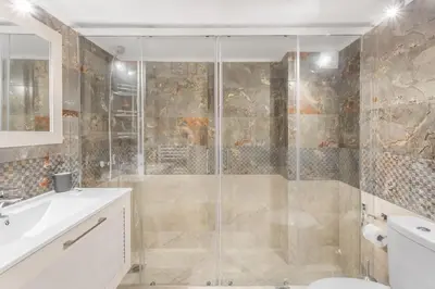 a bathroom with a shower and a toilet and a sink at Afroditi Suite in Athens