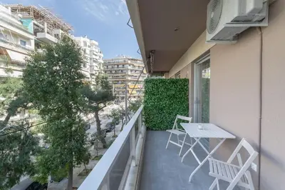 a balcony with a table and chairs on a building at Afroditi Suite in Athens