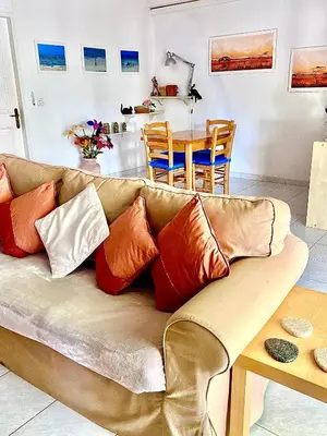 a couch with pillows on it in a living room at 2 Bedroom, Sea Side Retreat Saronida in Saronida