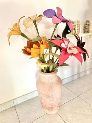 a pink vase with flowers in it on the floor at 2 Bedroom, Sea Side Retreat Saronida in Saronida