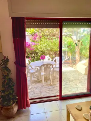 a sliding glass door with a table and chairs on a patio at 2 Bedroom, Sea Side Retreat Saronida in Saronida