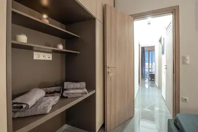 a room with a closet with towels on shelves at Minimalistic! in Athens