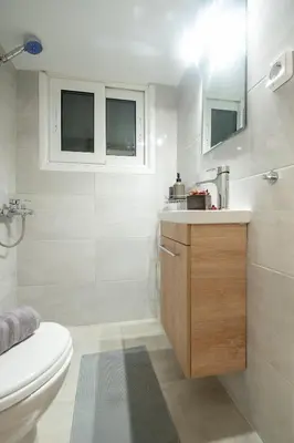 a white bathroom with a sink and a toilet at Minimalistic! in Athens