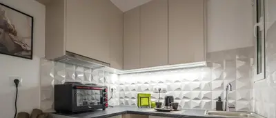 a kitchen with white cabinets and a microwave at Minimalistic! in Athens