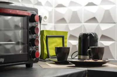two cups on a counter next to a microwave at Minimalistic! in Athens