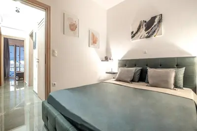 a bedroom with a large blue bed in a room at Minimalistic! in Athens