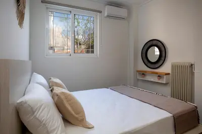a bedroom with a large bed with a window at Silk Mill Metaxourgeio, Athens Centre in Athens