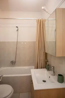 a bathroom with a sink and a tub and a toilet at Silk Mill Metaxourgeio, Athens Centre in Athens