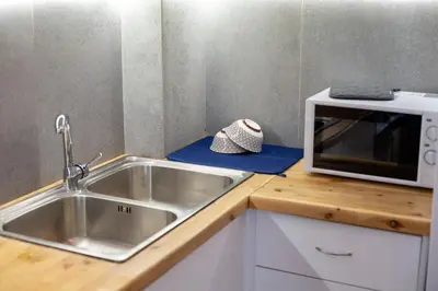 a kitchen with a sink and a microwave on a counter at Silk Mill Metaxourgeio, Athens Centre in Athens