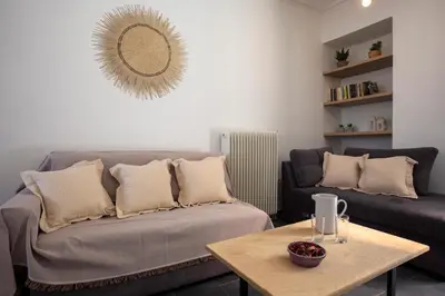 a living room with a couch and a table at Silk Mill Metaxourgeio, Athens Centre in Athens