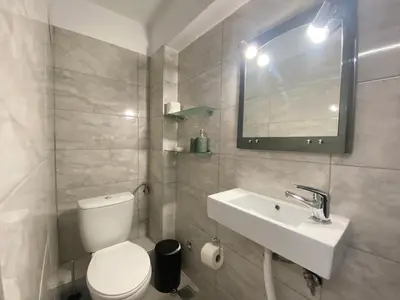 a bathroom with a toilet and a sink and a mirror at Silk Mill Metaxourgeio, Athens Centre in Athens