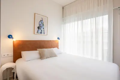 a bedroom with a white bed and a window at Kallithea Apartments by Olala Homes in Athens