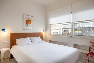 a bedroom with a large white bed and a window at Kallithea Apartments by Olala Homes in Athens